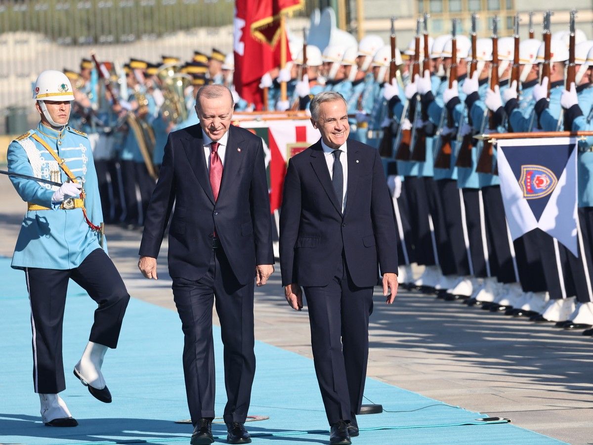 Turkish President Recep Tayyip Erdogan, left, walking with Canadian Prime Minister Mark Carney