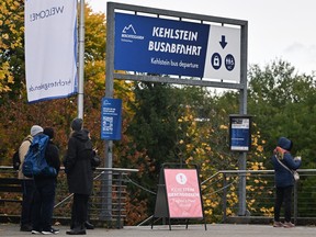 People wait near a bus stop for Kehlsteinhaus.