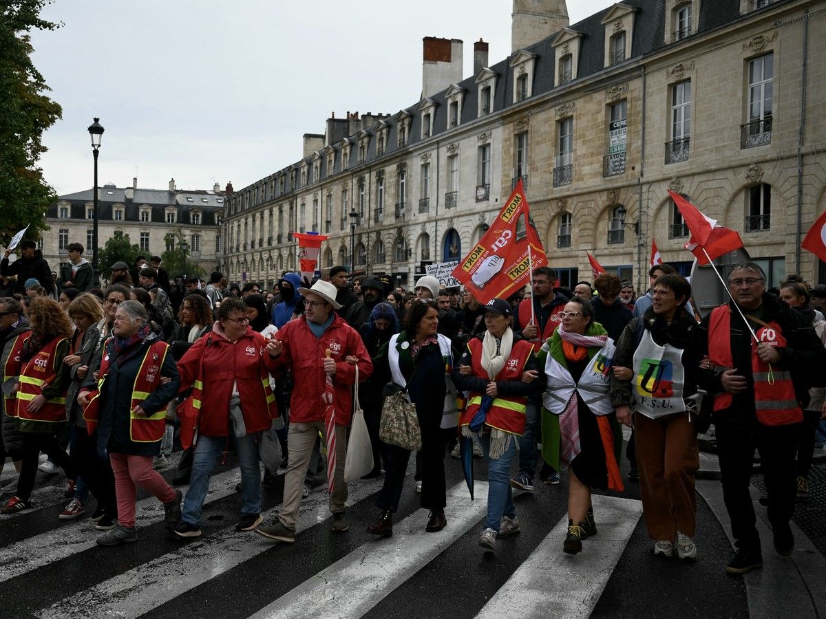 A group of protestors wearing red walk together.