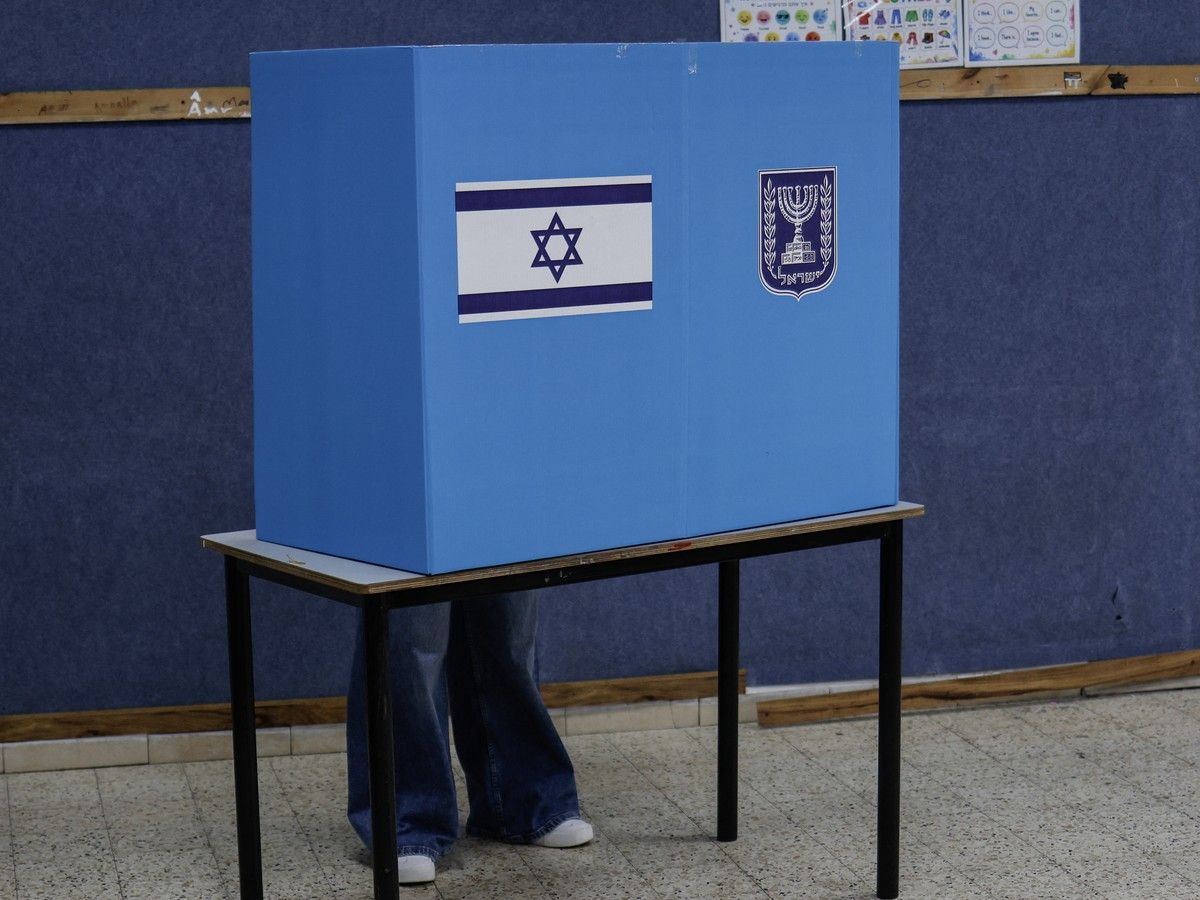 A person behind a voting screen in Israel
