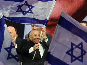 Yashar party leader Gadi Eisenkot waves Israel's national flag