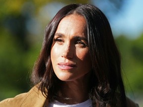 A close up of Meghan Markle with the sun on her face.