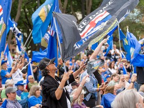 Crowd holding flags.