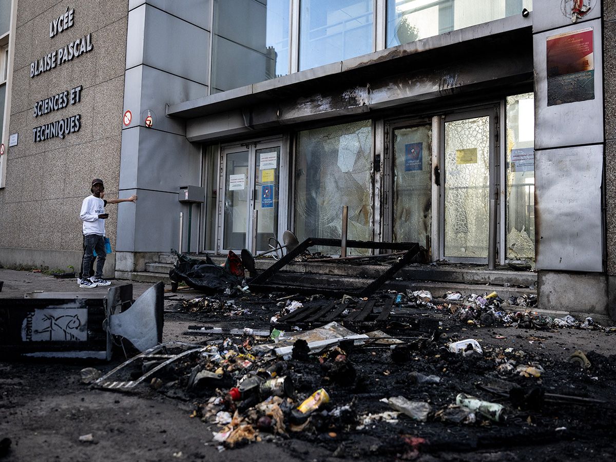Teens outside a vandalized school.