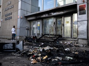 Teens outside a vandalized school.