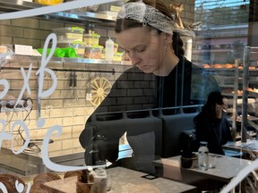 A female worker in the window of the Honey cafe in Kyiv, Ukraine.