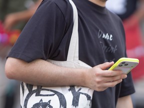 Man talks on cellphone on street.