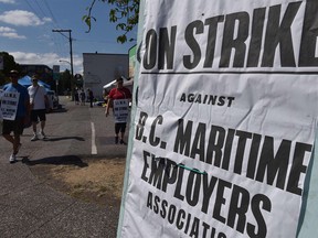 Longshore and warehouse workers picket in Vancouver.