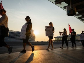 air canada flight attendants protest outside an airport on strike