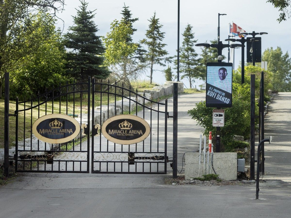 Iron gate with long driveway behind it