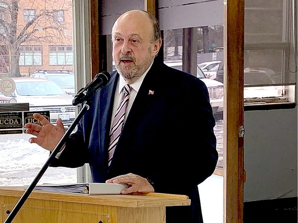 Middle aged man in suit at microphone