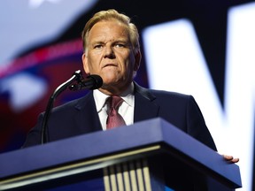 Mike Rogers speaks from behind a podium.