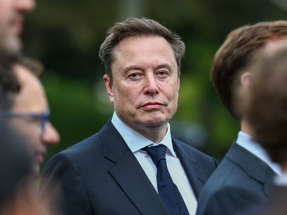 Elon Musk in a suit and tie