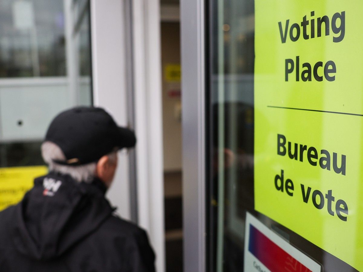 A man walks enters a polling station