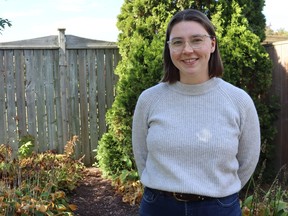 Woman stands in backyard
