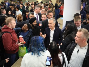 Mark Carney smiles while surrounded by students.