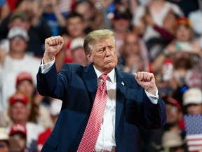 Donald Trump dances in front of a crowd.