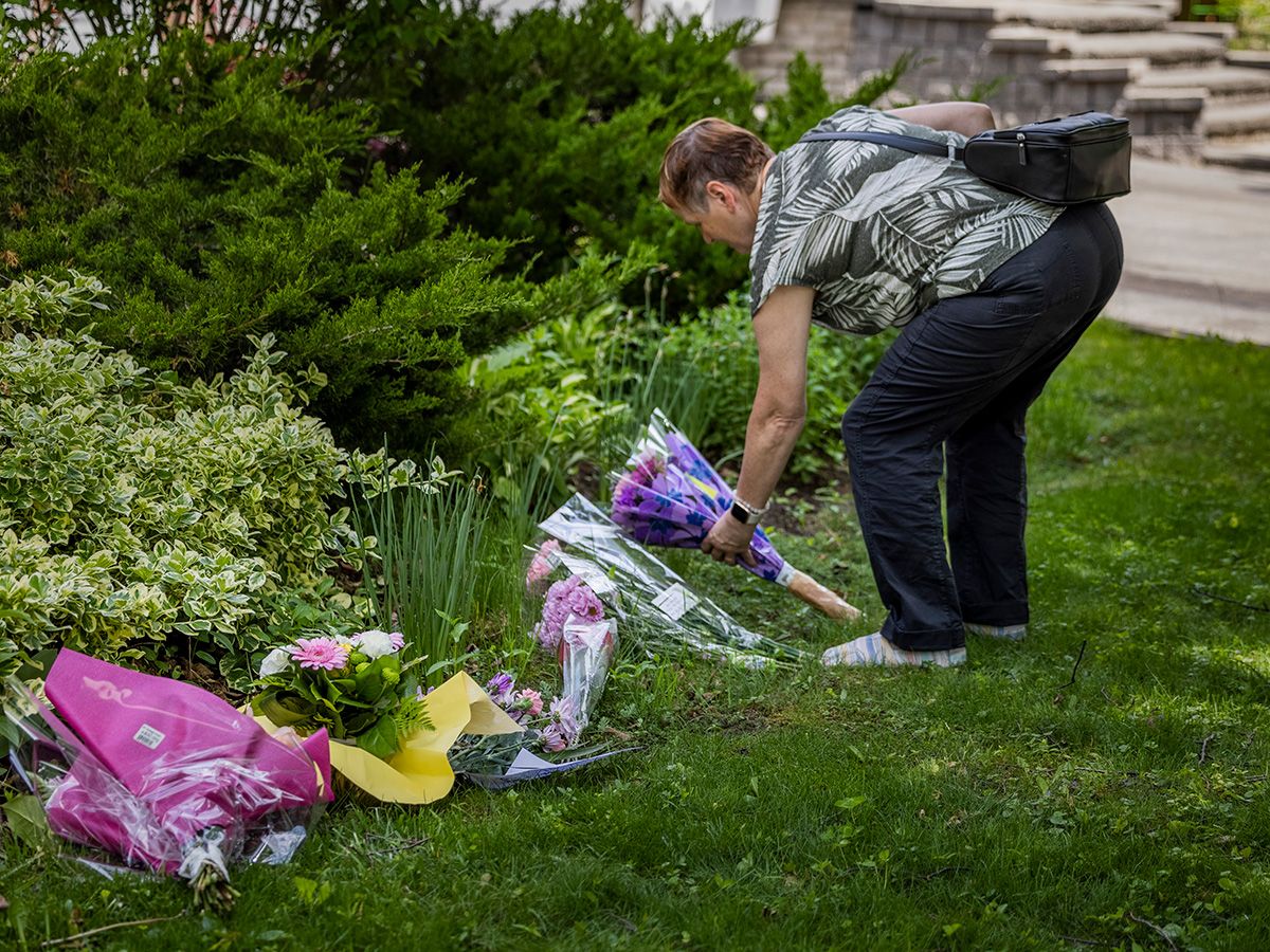  A woman places flowers at a makeshift memorial outside the home of Eleanor Doney, who was killed by a 14-year-old boy the previous day in Pickering, Ont., May 30, 2025.
