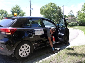 Josh Pommer, a larvicide technician for the St. Clair Region Conservation Authority, is shown treating a catch basin in Point Edward with larvicide in this file photo.