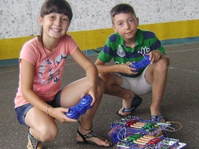 Olivia and Preston Samson put together the circuits to make the car operate with a remote at the Science North's 'Make it Move' workshop held recently at the Bill Barber Community Centre and sponsored by the Callander Library. Eva MacWilliams Photo