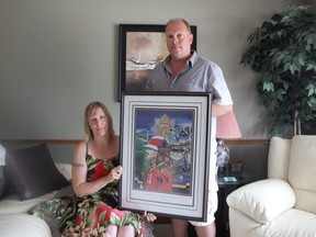 Tara Hill and Bill Shepherd, Larrys children, hold a drawing of their father done out of a picture of him at the historic Wolseley Barracks on Oxford Street in London. (Jonathan Juha/Strathroy Age Dispatch)