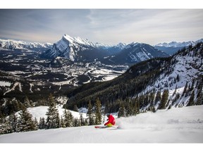 This undated photo provided by Mount Norquay shows a snowboarder on the mountain in the Canadian Rockies, just 15 minutes from the town of Banff, Alberta. It's one of a number of small resorts located near larger, big-name resorts. While the small places don't have as much terrain, they have shorter lines, lower costs and a more relaxed atmosphere.