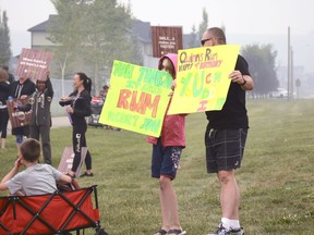Supporters hold up signs at the kickoff of Quinn's Legacy Run on Saturday, Aug. 18.