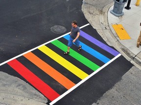 In this 2018 photo, a pedestrian walks across the rainbow crosswalk at Forsyth Street along King Street West in Chatham. (Tom Morrison/Postmedia Network)