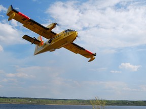 File photo of Bombardier CL415 water bomber flying over Timmins.
Postmedia File Photo