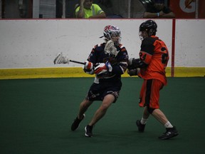 Mohawk Medicine Men player Mick Miller (24) works over a North Shore (Quebec) Kodiaks ball carrier, at the Founders Cup junior B nationals. Photo on Friday, August 17, 2018, on Cornwall Island, Ont. Todd Hambleton/Cornwall Standard-Freeholder/Postmedia Network