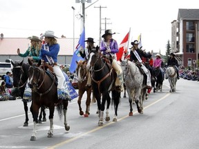 Various members of rodeo royalty wave to onlookers of the 2016 Labour Day Parade in Cochrane, Alta. on Monday, Sept. 5, 2016. (David Feil/Cochrane Times/Postmedia Network)