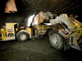A front end loader dumps a bucket full of copper and nickel ore into a 40-ton truck in this file photo.