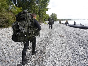 Patrol Pathfinder trainees head to their rendezvous point Friday, August 31, 2018 on a Crown land beach near Point Petre in Prince Edward County.