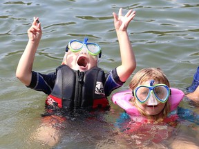 Alex Grove, left, and his sister, Aubrey, cool off at Meatbird Lake Park in Lively, Ont. on Friday August 17, 2018. The park has since been sold to Vale for $4 million and the city is now looking at how to spend the money. John Lappa/Sudbury Star/Postmedia Network