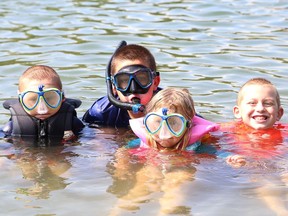 The Grove family, which includes Alex, 6, left, Ethan, 10, Aubrey, 5, and Joshua, 8, cool off at Meatbird Lake Park in Lively, Ont. on Friday August 17, 2018.