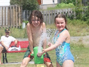 Owen Wyatt and his sister, Avan, cool off at the Morel Family Foundation Park splash pad off of Second Avenue in Sudbury, Ont. on Tuesday August 7, 2018.