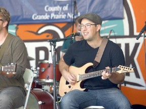 left to right: Northbloods lead singer Zachary Kay belts out a tune while Northbloods guitar player Nelson Horneland lays down a lick at the Bear Creek Folk Fest at Muskoseepi Park on Saturday morning. Horneland also plays bass for the band as well.