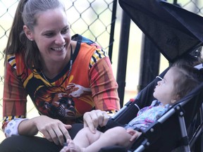 Michelle Denneny visits with seven-month-old Penny Diberardino before start of Thursday's official opening of Sault College's early learning centre.