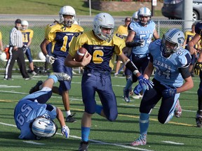 Notre Dame Alouettes quarterback Andrew Gauthier (6) runs the ball while the St. Benedict Bears' Austin Mader (34) rushes to defend during SDSSAA senior boys football action at James Jerome Sports Complex in Sudbury, Ontario on Friday, September 14, 2018. St. Benedict won 45-0.  In the late game Friday, the Lo-Ellen Knights beat the St. Charles Cardinals 38-7.