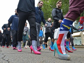 Hundreds of high-heeled men 'step up' against domestic violence. They will Walk a Mile in Her Shoes to raise funds for women's help groups.