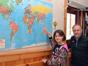 Visiting the Justin Bieber Steps to Stardom exhibit Friday from her home in Sydney, Australia, Chloe Rennie places a pin on the museum's world map with general manager John Kastner. Galen Simmons/The Beacon Herald/Postmedia Network