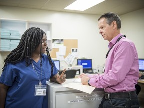 Doctors Julie-Ann Francis and Hugh Langley confer at the Cancer Centre of Southeastern Ontario. They're promoting free pap tests to check for cervical cancer. (Cancer Centre of Southeastern Ontario/Supplied Photo)