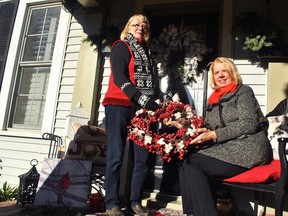 Florist and designer Laurie Clark and Marianne Johnstone from IODE Captain Garnett Brackin are shown outside a decorated home on Wellington Street West in Chatham in this file photo from Oct. 25, 2018.