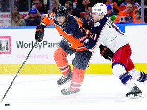 The Edmonton Oilers' Darnell Nurse (25) battles the Columbus Blue Jackets' Matt Calvert (11) during second period NHL action at Rogers Place, in Edmonton Tuesday March 27, 2018. Photo by David Bloom