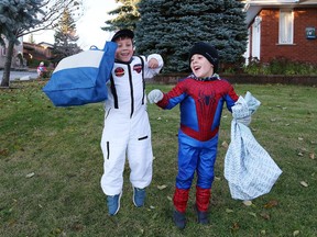 Luca Gauthier, 6, left, and Jeremie Neale, 5, had their bags ready to fill with treats on Halloween in Sudbury, Ont. on Wednesday October 31, 2018.