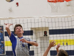 Tylor Davidson, left, of Sacre-Coeur Griffons, attempts to hit the ball past Andrew Lewis, of the Bishop Carter Golden Gators, during high school volleyball action at Bishop Alexander Carter Catholic Secondary School in Hanmer, Ont. on Monday October 22, 2018. John Lappa/Sudbury Star/Postmedia Network