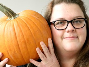 Jessica Laidley, food resource centre co-ordinator at Harvest Algoma, holds a pumpkin in Sault Ste. Marie, Ont., on Tuesday, Oct. 30, 2018. (BRIAN KELLY/THE SAULT STAR/POSTMEDIA NETWORK)