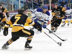 Quinton Byfield, right, of the Sudbury Wolves, attempts to elude Kade Landry, of the Hamilton Bulldogs, during OHL action at the Sudbury Community Arena in Sudbury, Ont. on Friday October 19, 2018.