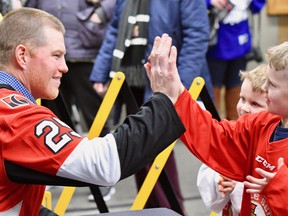Chris Neil greets a young fan at Memorial Gardens on the occasion of Chris Neil Night as the North Bay Battalion faced the Sudbury Wolves in Ontario Hockey League action in 2018. Neil, an Ottawa Senators alumni ambassador, signed autographs and posed for photos with hundreds of fans, many of whom remembered his storied three seasons with the North Bay Centennials, and conducted the ceremonial faceoff. Sponsored by the Senators, the evening also featured an appearance by mascot Spartacat. Sean Ryan, File photo