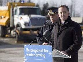 Jeff Yurek, minister of Transportation, is joined by Chief Superintendent John Cain of OPP West Region on Friday to announce drivers can now track the location of snow plows and salt trucks on provincial roads and highways on all of the Ontario 511 platforms. 
Derek Ruttan/Postmedia